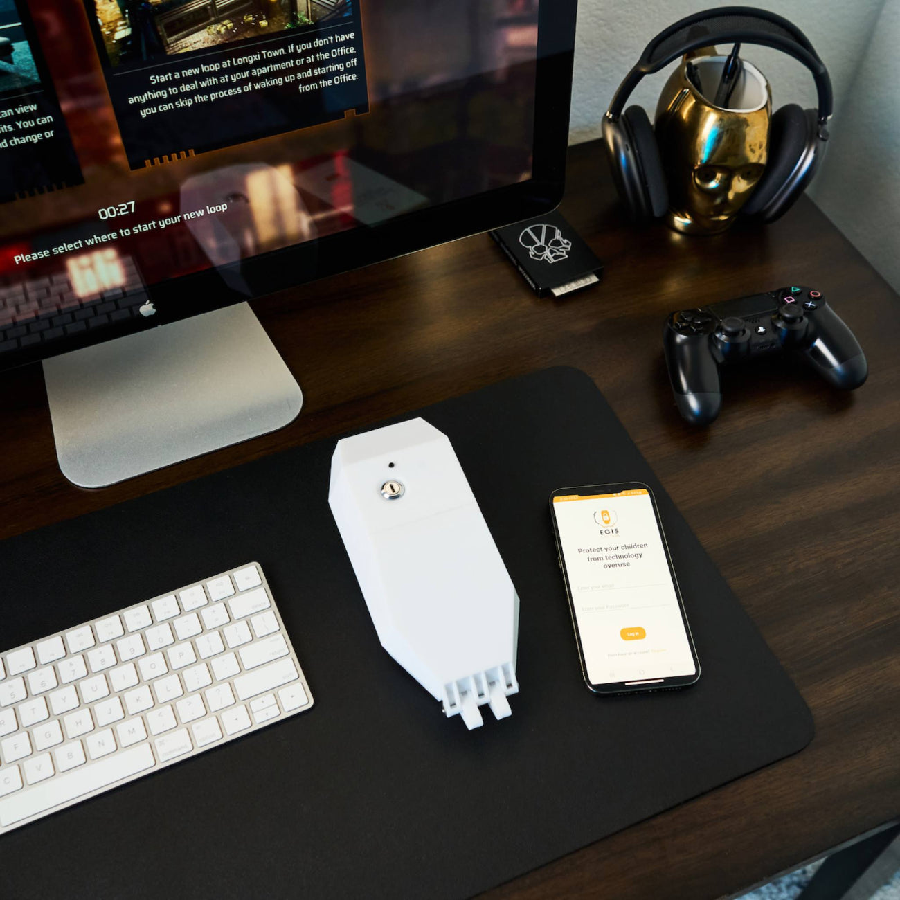 Image of locking smart plug device alongside smart phone app on desk.