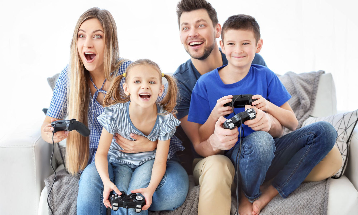 Happy family of four playing video games