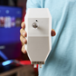 Sleek Egis Control device being held by hand.